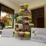 A tower of beautifully decorated cupcakes displayed in the sunlit dining area of a luxury holiday home