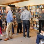 A relaxed social gathering at a luxury holiday home, with guests enjoying conversation