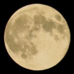 A close-up view of a bright full moon