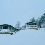 snow blankets the landscape and invites you to cozy up inside a warm cabin