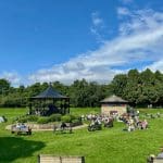 Audience enjoying a performance in the bandstand at Warren Forest Park