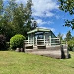 Holiday home with a wooden deck at Warren Forest Park