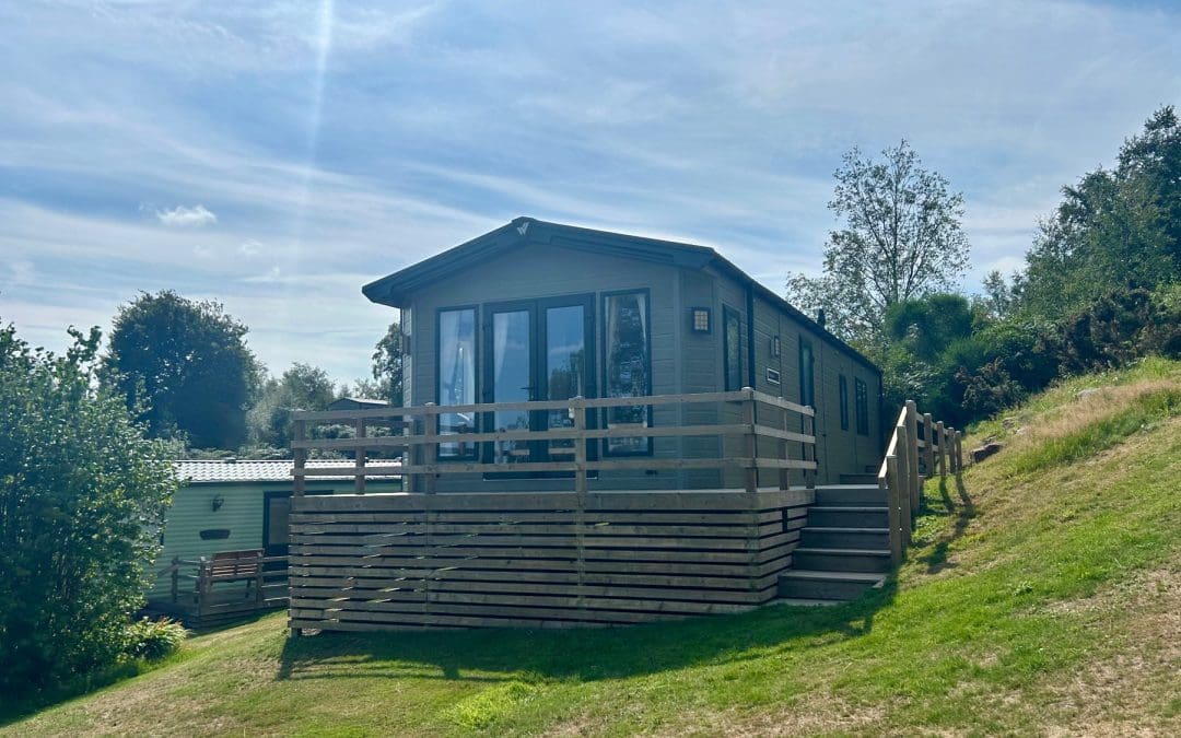 Modern holiday lodge with a wooden deck at Warren Forest Park