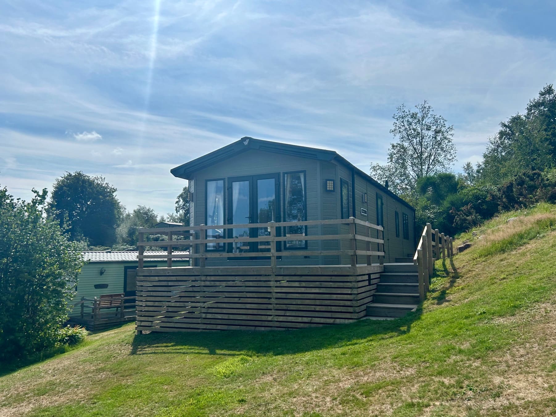 Modern holiday lodge with a wooden deck at Warren Forest Park