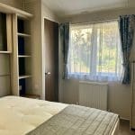 Bright and cosy bedroom in a holiday lodge at Warren Forest Park