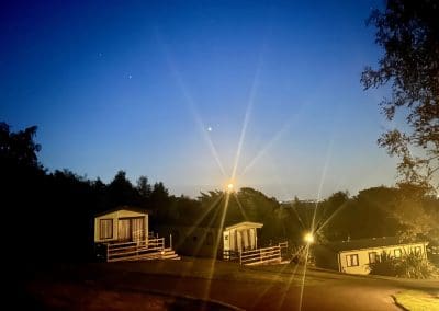 Night view of holiday lodges at Warren Forest Park