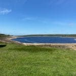 Grimwith Reservoir with green grass at Warren Forest Park