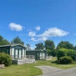 Holiday homes and pathway surrounded by greenery at Warren Forest Park