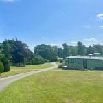 Holiday homes and pathway at Warren Forest Park on a sunny day