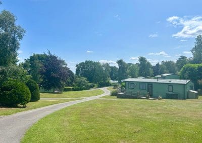 Holiday homes and pathway at Warren Forest Park on a sunny day