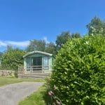 Holiday home with a deck and lush greenery at Warren Forest Park