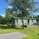 Holiday home with a deck and tree at Warren Forest Park
