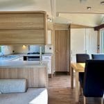 Modern kitchen and dining area in a caravan at Warren Forest Park