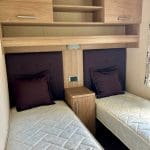 Comfortable twin bedroom in a caravan at Warren Forest Park