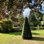 Beautifully manicured garden with topiary and a serene pond at Warren Forest Park